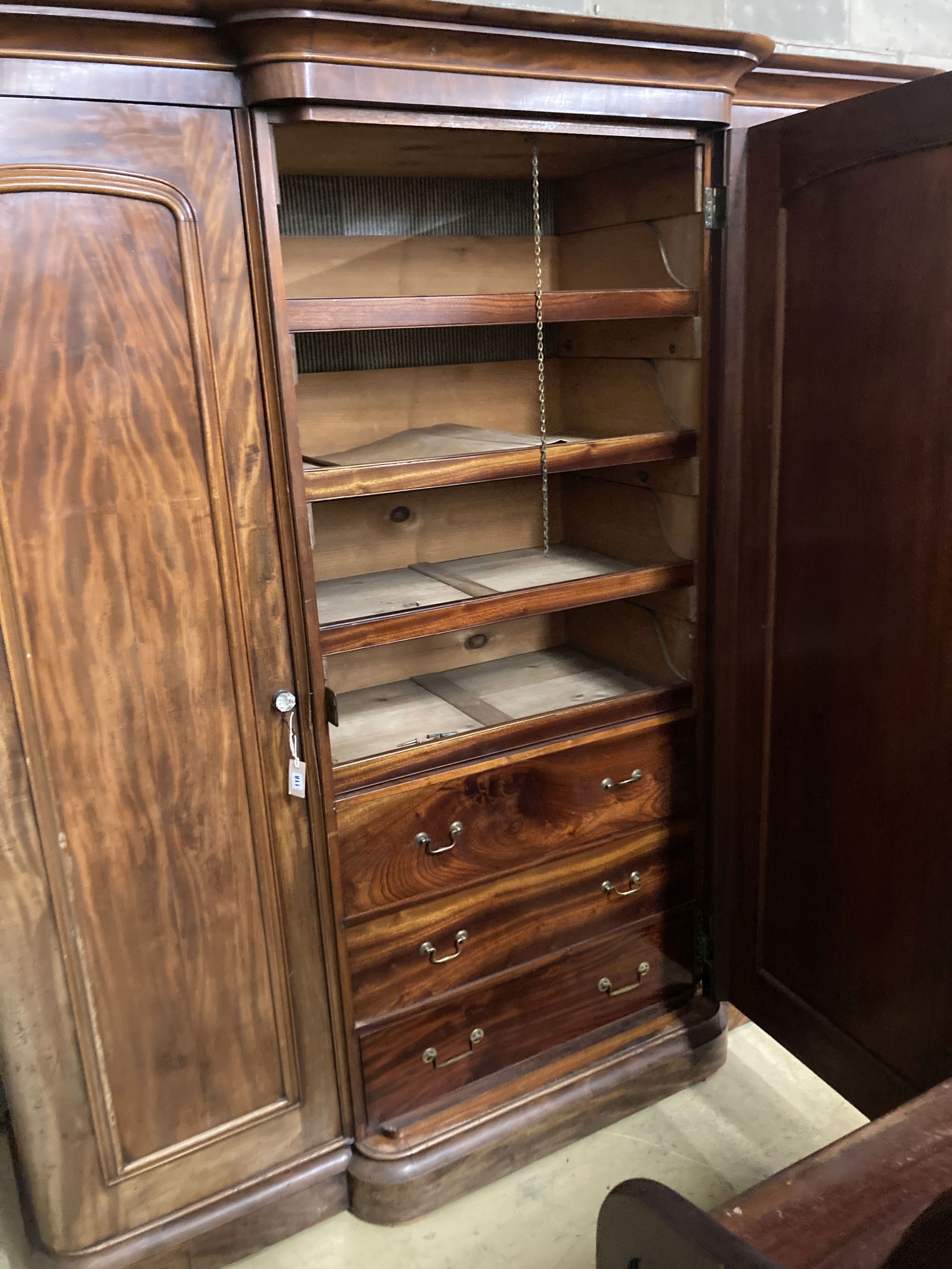 A large Victorian mahogany break front compactum three door wardrobe, length 230cm, depth 60cm, height 226cm